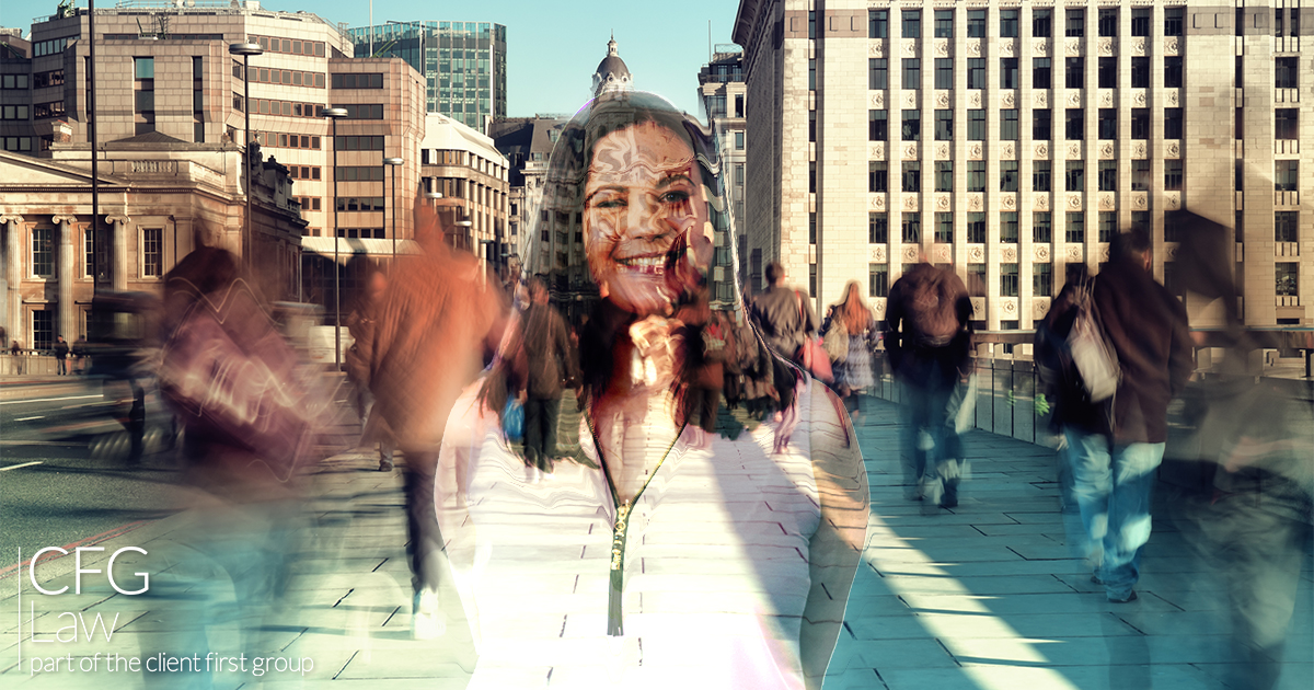 A smiling woman is transparent allowing view of passing foot traffic through her